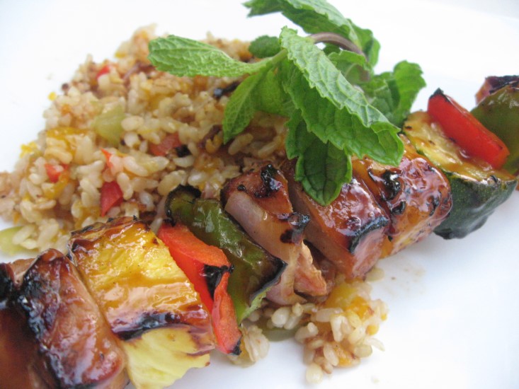 terriyaki pork kabobs plated with rice and mint garnish from the Kitchen Project