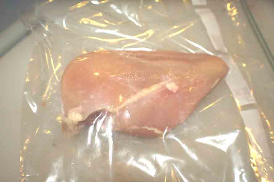 boneless skinless chicken breast in a clear plastic storage bag