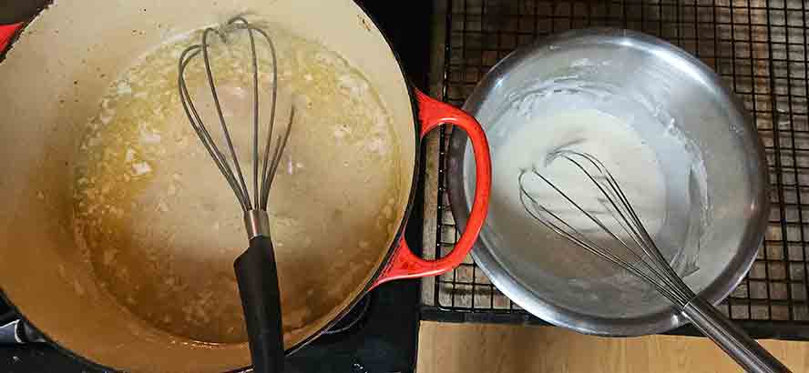 Add the stock slowly while whisking constantly to ensure the roux incorporates perfectly for a lump-free sauce.