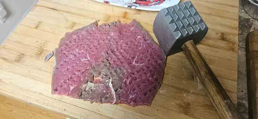 Tenderizing the Beef Schnitzel with the claw part of the mallet. 