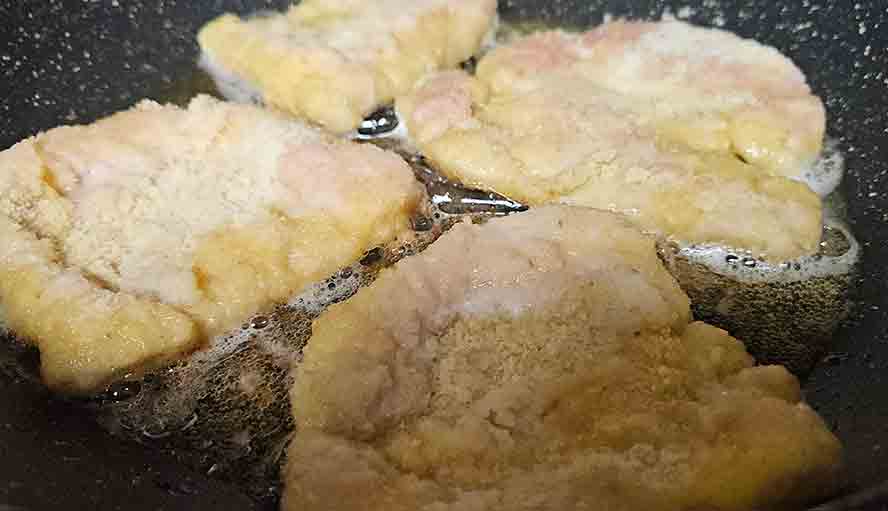 Schnitzels browned on one side, ready to turn. 