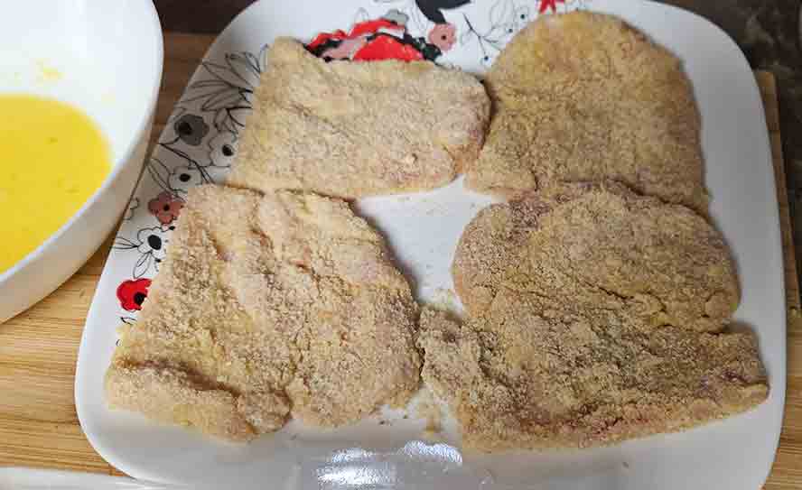 Breaded Schnitzels resting on a plate. 