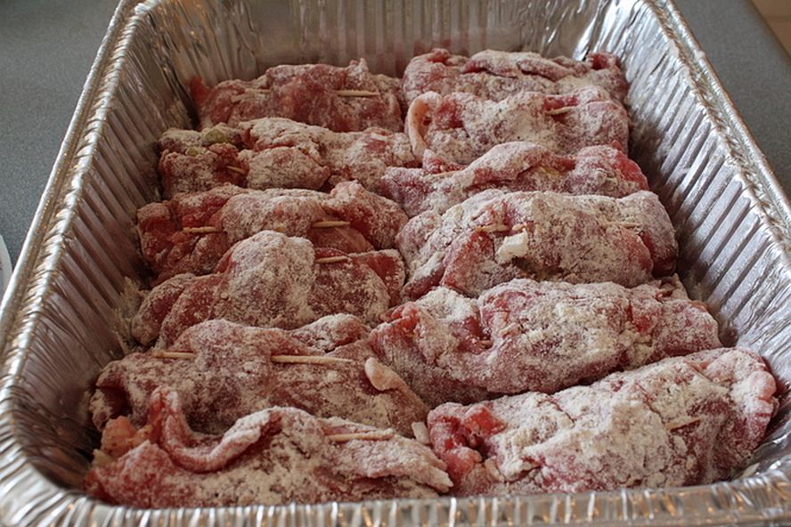 Batch of rouladen coated in flour and ready for cooking