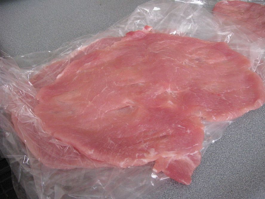 thin flattened pork schnitzel ready for breading and cooking