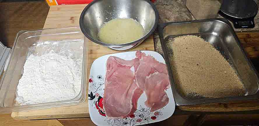 schnitzel-breading-2 pork schnitzel coated lightly in flour before breading