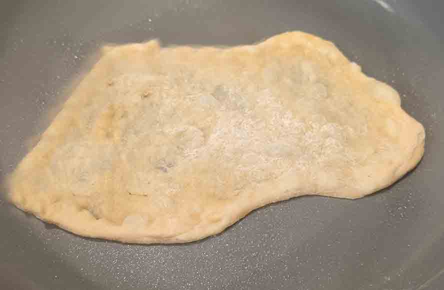 dough-in-pan Put the stretched dough in a skillet
