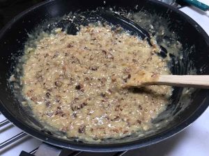 nuts and coconut folded in the filling , ready to frost cake.