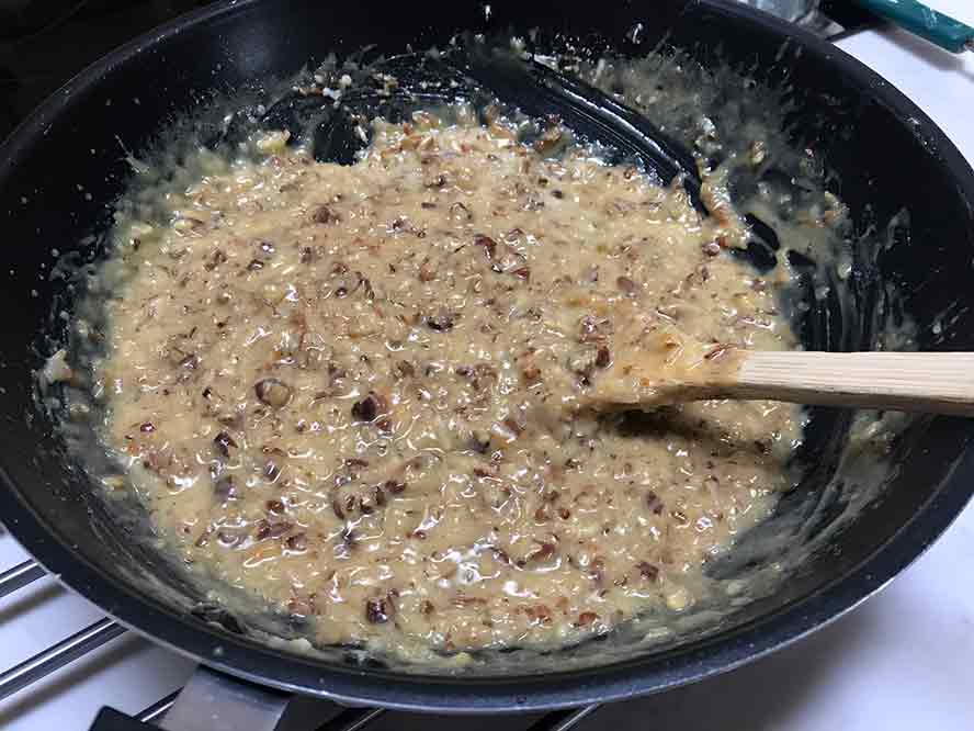 nuts and coconut folded in the filling , ready to frost cake.